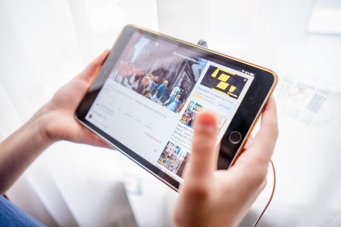 An image of a person watching a video on a tablet
