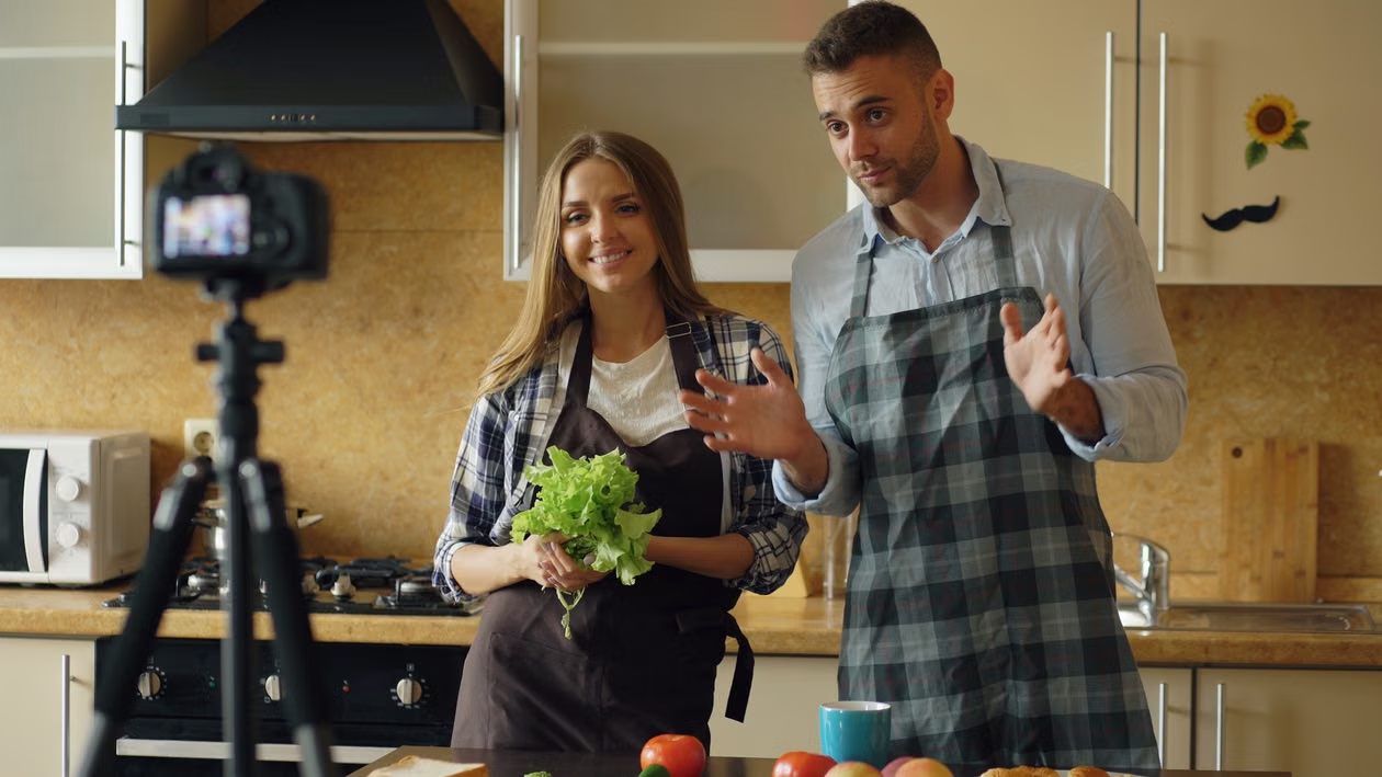 An image of a couple recording a cooking video