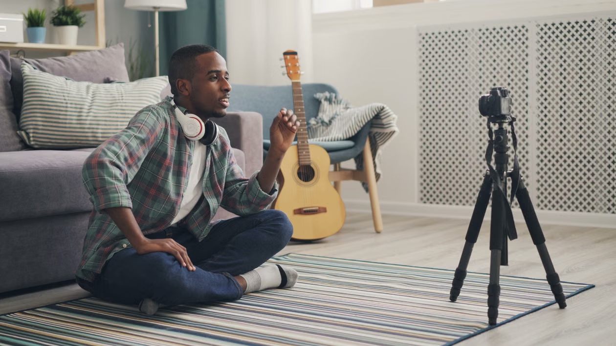 An image of a man recording a video about music